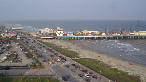 Drone-view-of-the-Pleasure-Pier-and-Galveston-Beach-in-Galveston,-Texas