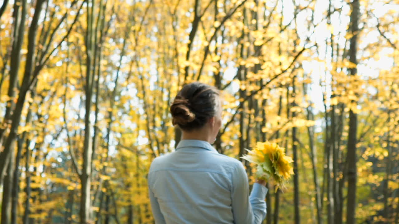 Woman relaxing in park. Happy attractive woman relaxing in sunny autumn park