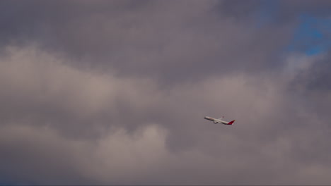 sunlit plane climbing in sky