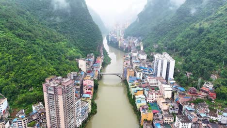 Yunnan-city,-Yanjin-county,-narrowest-city-in-the-world-from-high-above,-cloudy-drone-overview