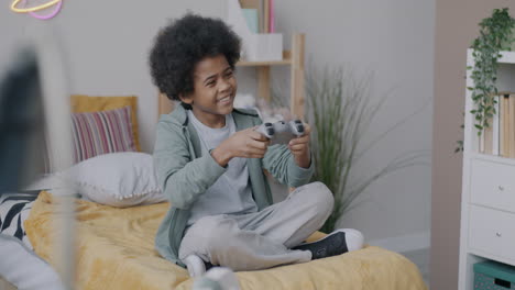 happy child playing video games in bedroom