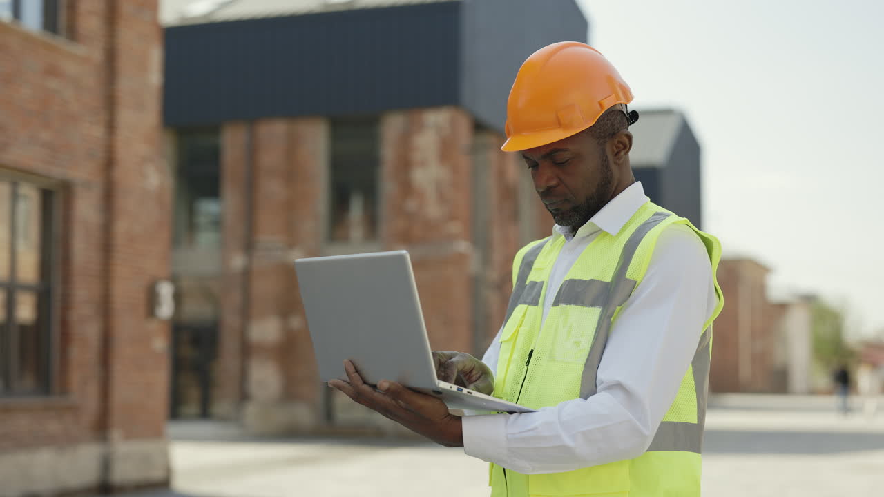 Construction worker using laptop on a construction site