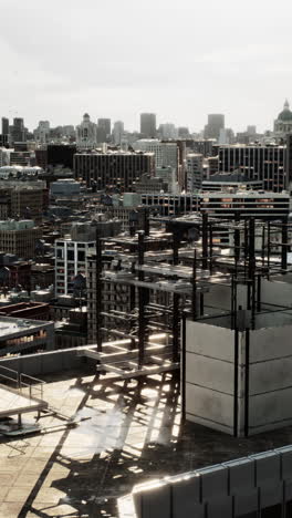 a rooftop view of a city skyline with construction underway