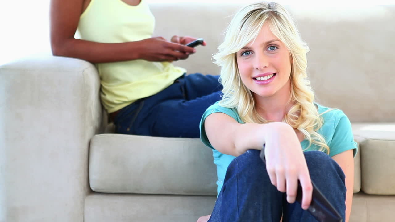 Blonde watching TV on the floor