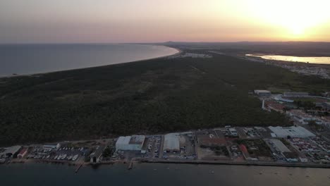 Aerial-View-of-the-Coastal-village-of-Vila-Real-Santo-Antonio-at-Sunset