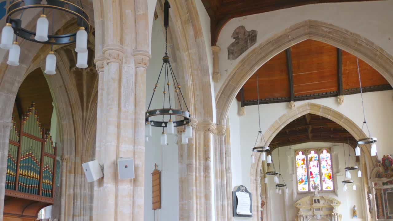 Interior of a Grand Church with Arched Architecture and Stained Glass