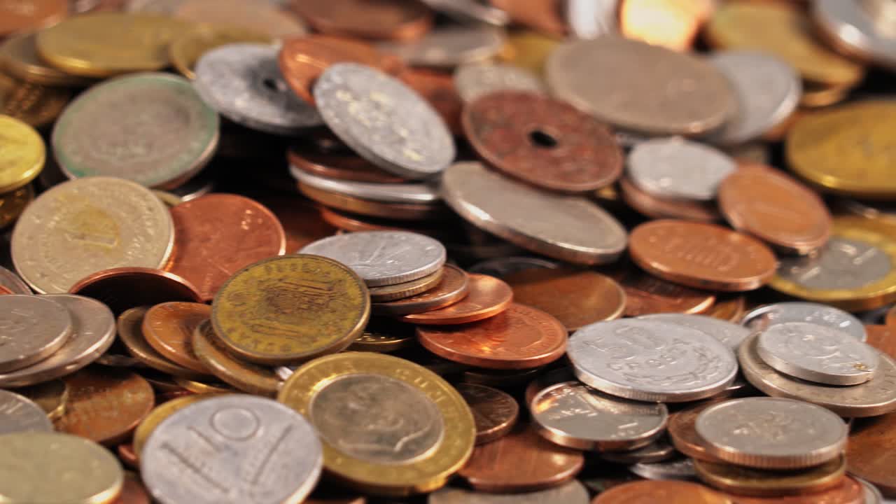 Coins arranged on a surface with mixed sizes and colors in close view
