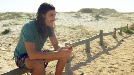 man using mobile phone on the beach 4k