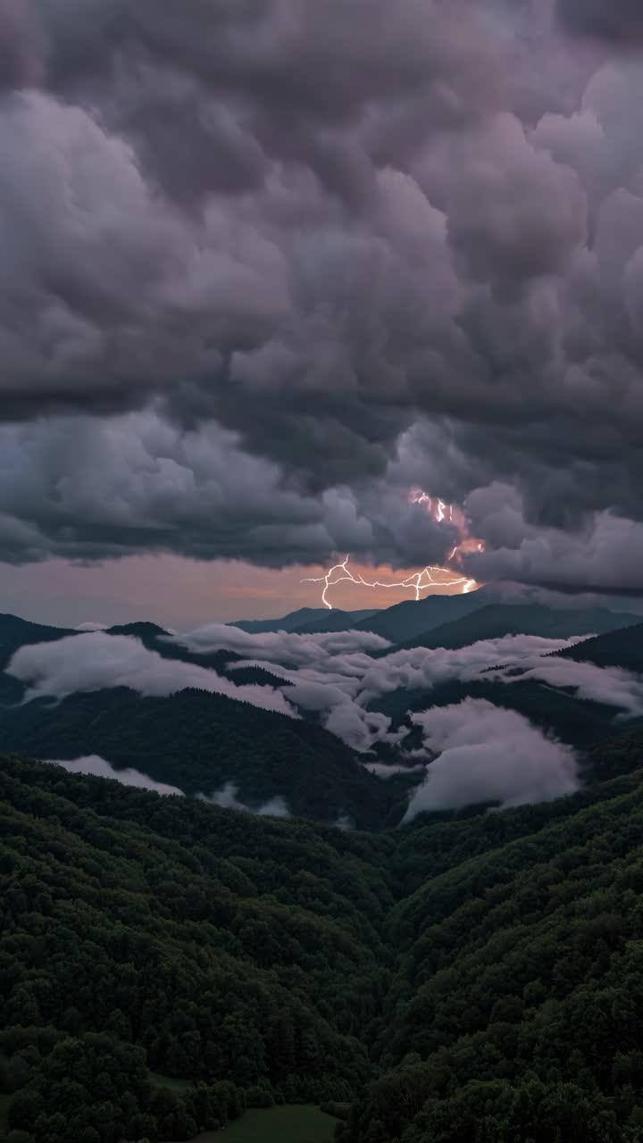 Dramatic aerial view of a lush valley under stormy skies with lightning, resembling a cinematic
