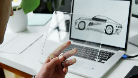Car-designer-using-glass-digital-tablet-in-office-4k