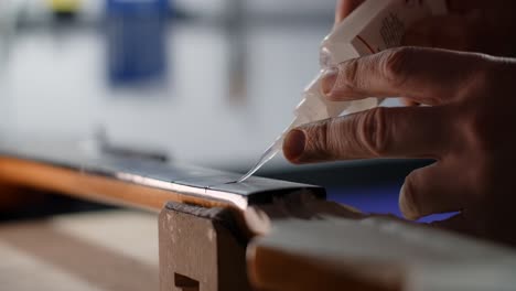 applying glue to a guitar neck