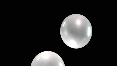 watch as four gleaming silver balloons gracefully float downward, their reflective surfaces shimmering. the scene is enhanced by seamless background removal, creating a mesmerizing visual display.