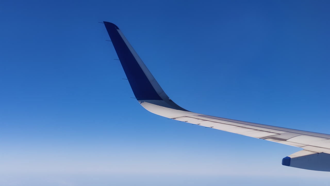 Aerial view of airplane wing in afternoon, conveying calm and freedom