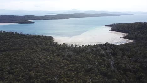 drone footage moving left showing green island beaches