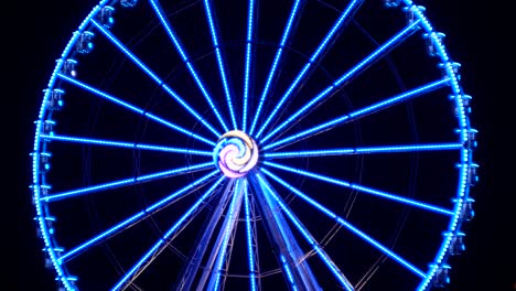 ferris wheel at night. illumination and multi-colored lights flashing