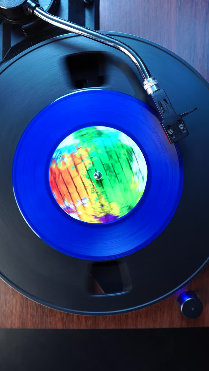Vertical View, Starting Playback of Single Vinyl Record With Blue Plastic and Colorful Sticker, Top Down View