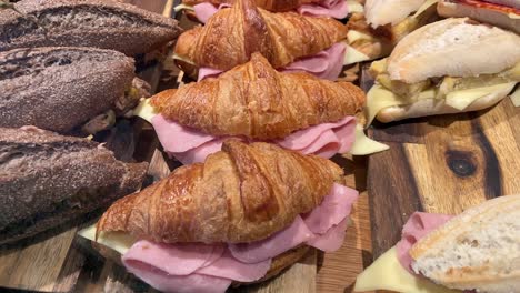 a variety of sandwiches with different breads and fillings on a board