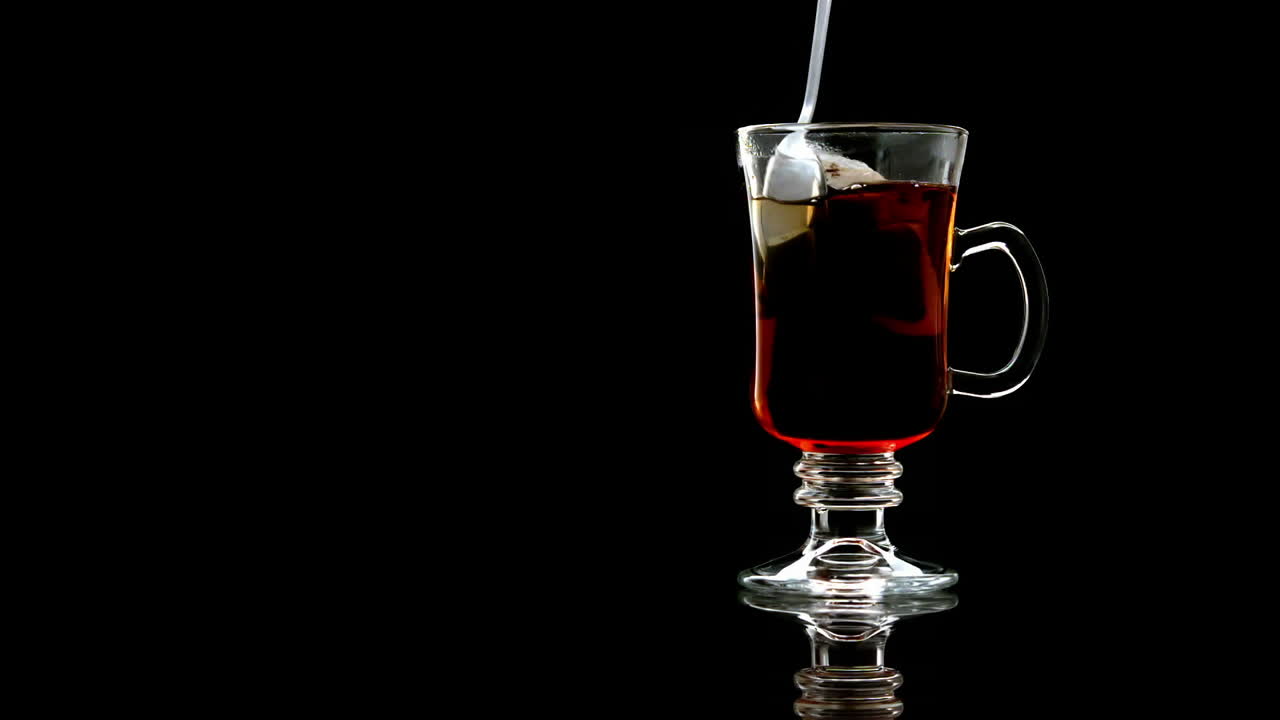 Spoon stirring tea in a glass