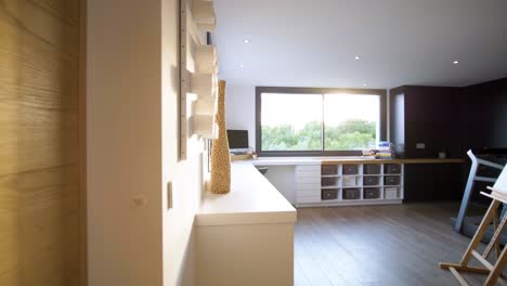 slow establishing shot of a home office with a wooden easel and a treadmill