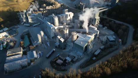 industrial excavation with lorries and smoke