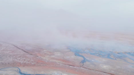 geothermal steam vents and hot springs in a volcanic plain, iceland.