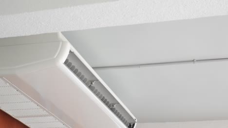 white air conditioner unit mounted on the ceiling