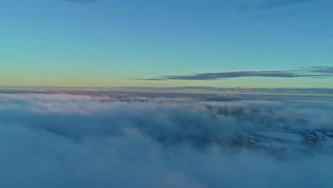 above the clouds at dawn with a serene view of the sky gradient, tranquil and expansive