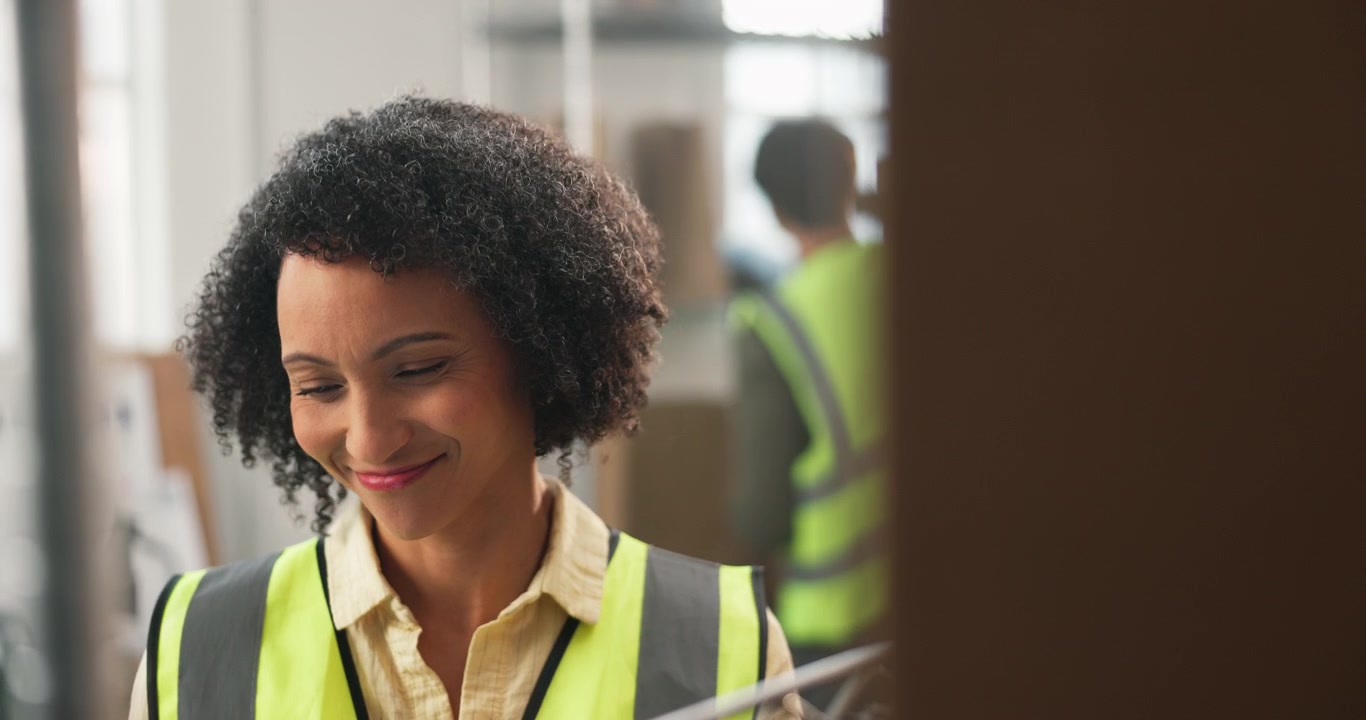 Female Warehouse Manager Writing on Clipboard in Distribution Center