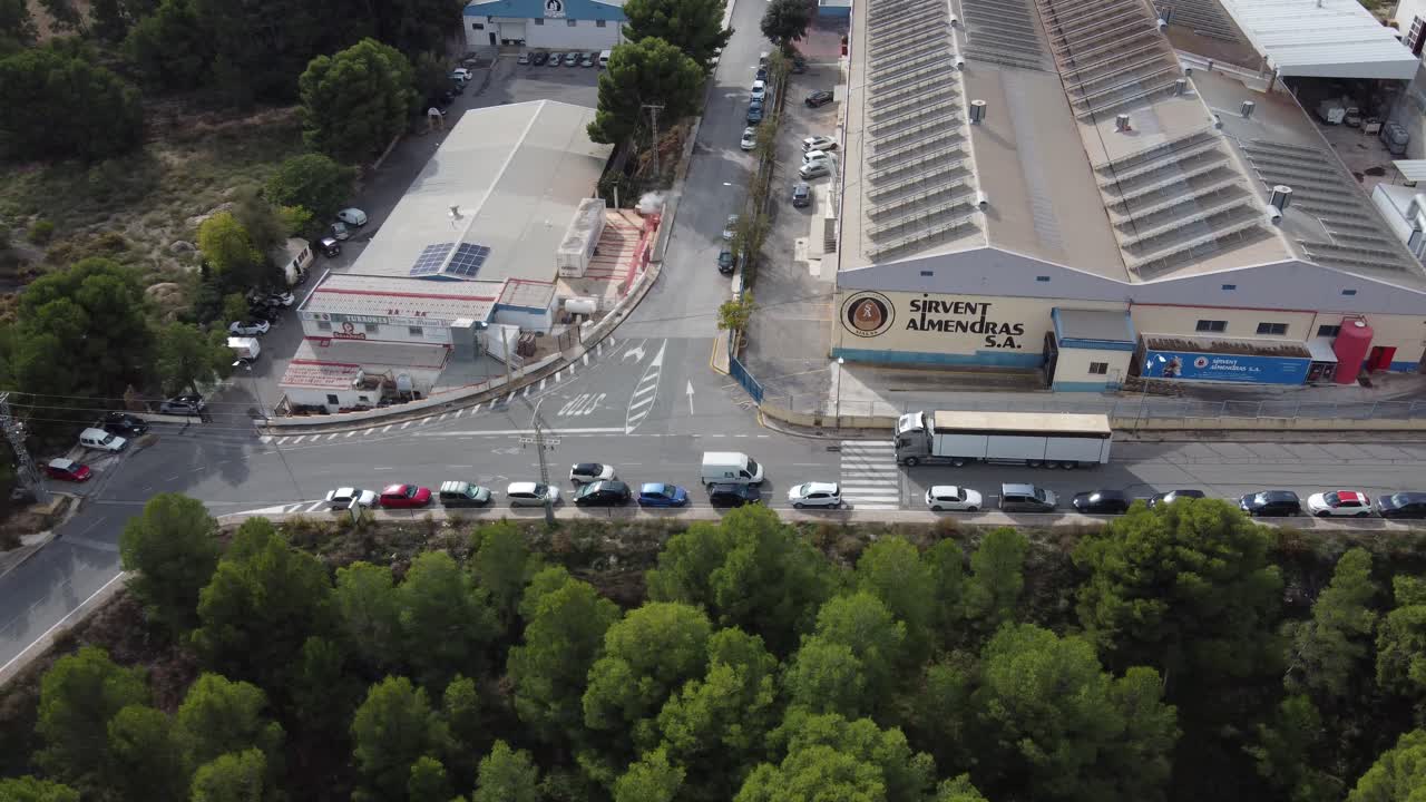 Aerial shot of a truck passing in front of Sirvent roasted almonds factory