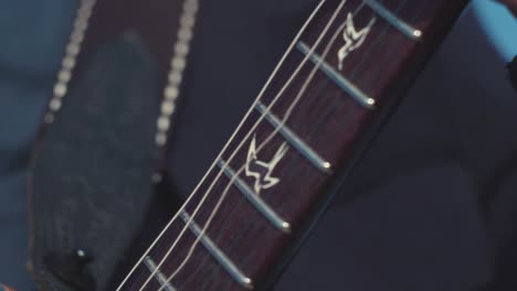 close-up of a guitarist playing an electric guitar