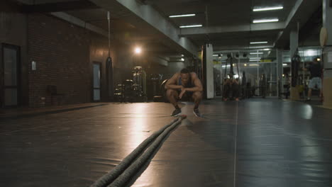 camera zooming on an athletic african american man in the gym.