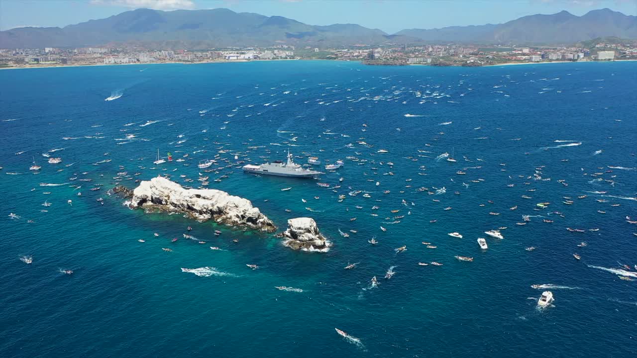 Aerial view of boats gathering for Virgen del Valle procession at sea