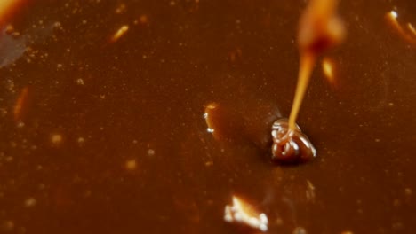 caramel being mixed in melted chocolate 4k