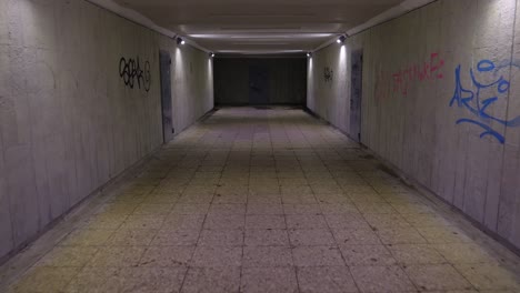 walking in the underground passage in the night, graffiti