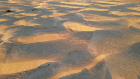 drone video of desert sandunes at sunset