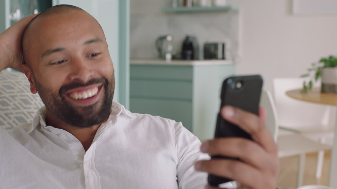 joven atractivo teniendo video chat usando smartphone en casa mostrando su peinado charlando compartiendo estilo de vida disfrutando de la comunicación en línea