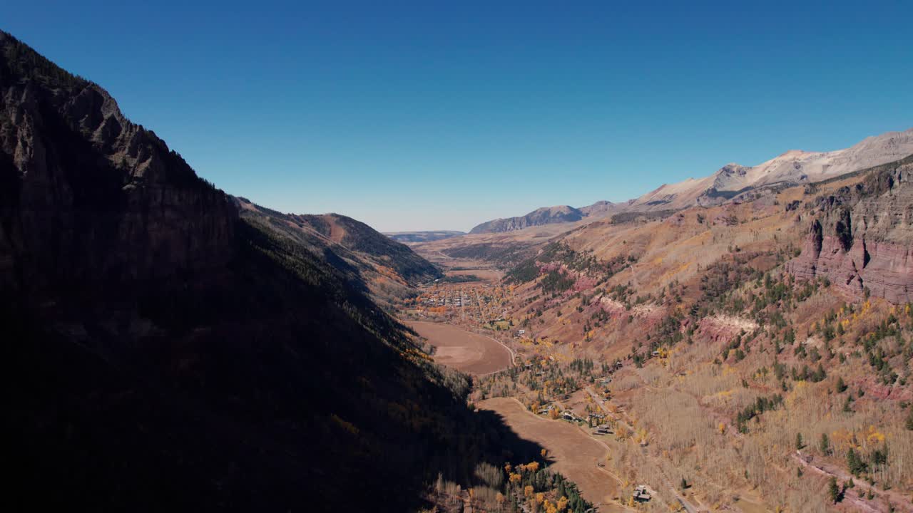 una foto de un dron muy distante que muestra todo telluride, colorado en el valle de las montañas.
