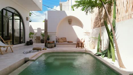 aerial of white tropical villa with turquoise pool design concept in bali