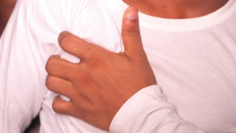 person touching their chest