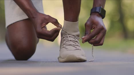 man tying his running shoes