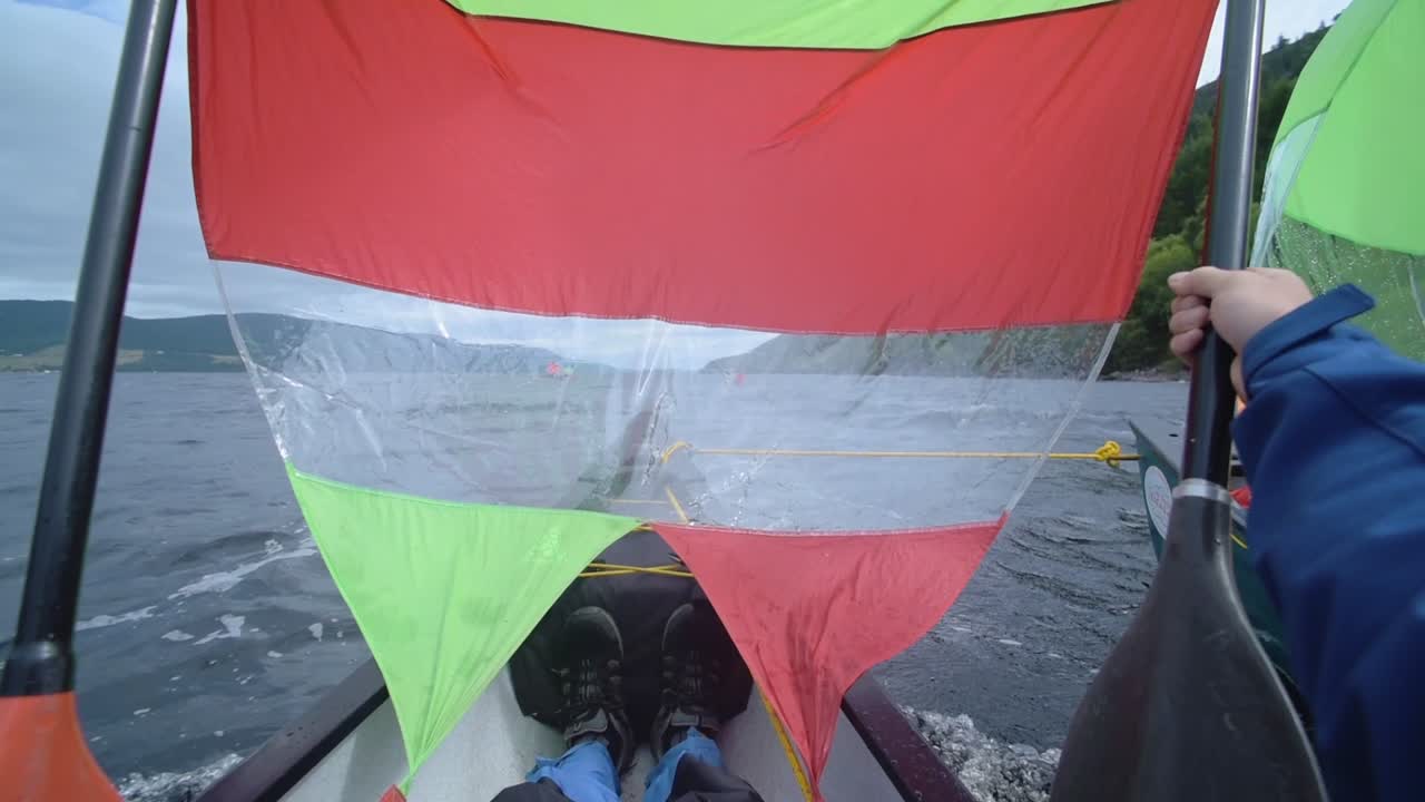 A Tourist Sailing In A Canoe In The Waters Of Loch Ness In Caledonian Canal Located In Scotland. -medium shot