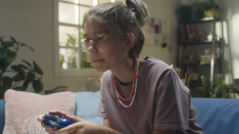 young person playing video games at home