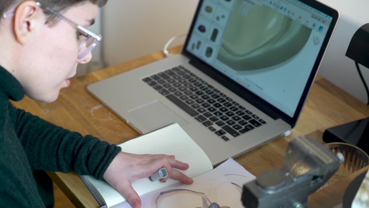 Product designer creating concept art in a notebook