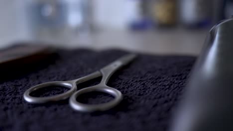 mens beard scissors and hair care products-tools on a bathroom counter