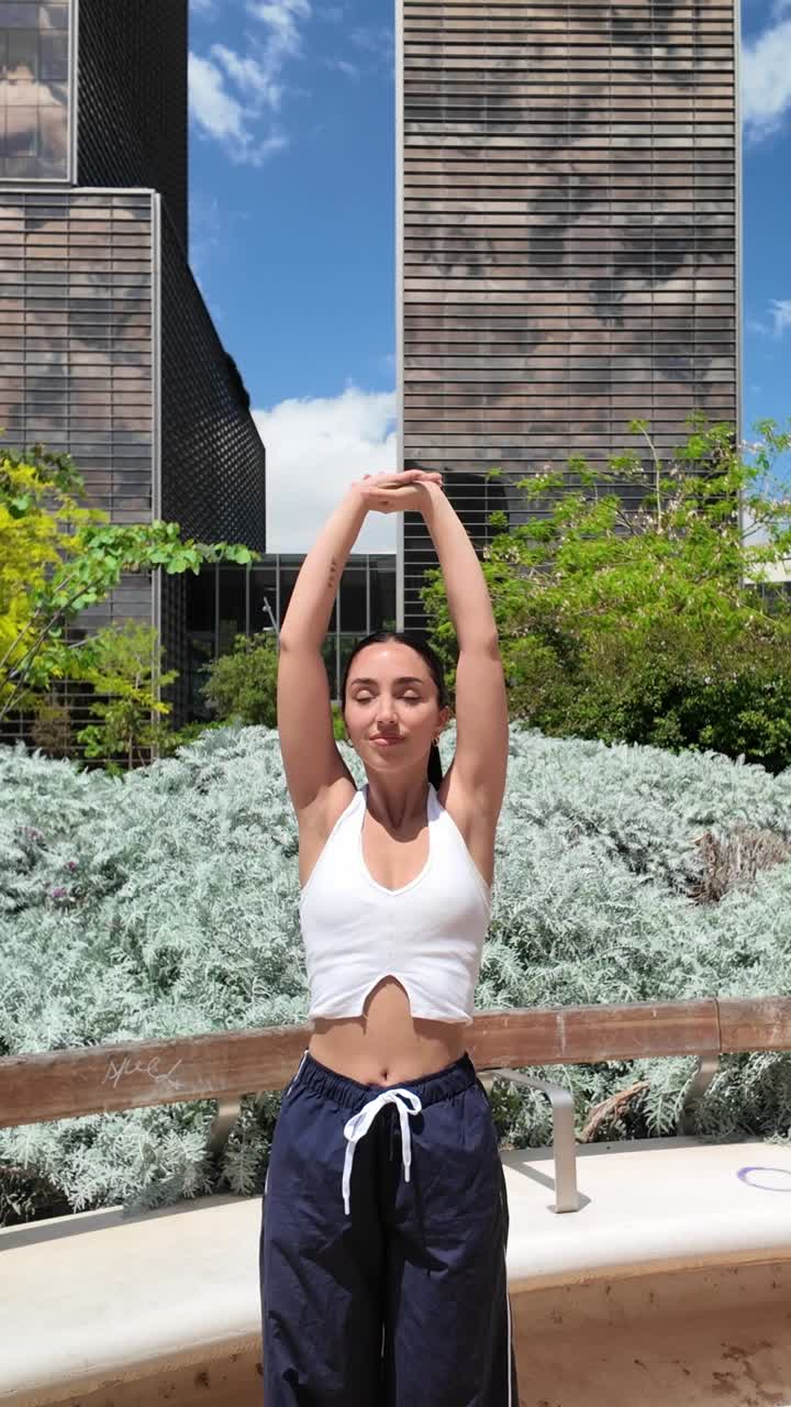 Woman stretching outdoors in an urban setting