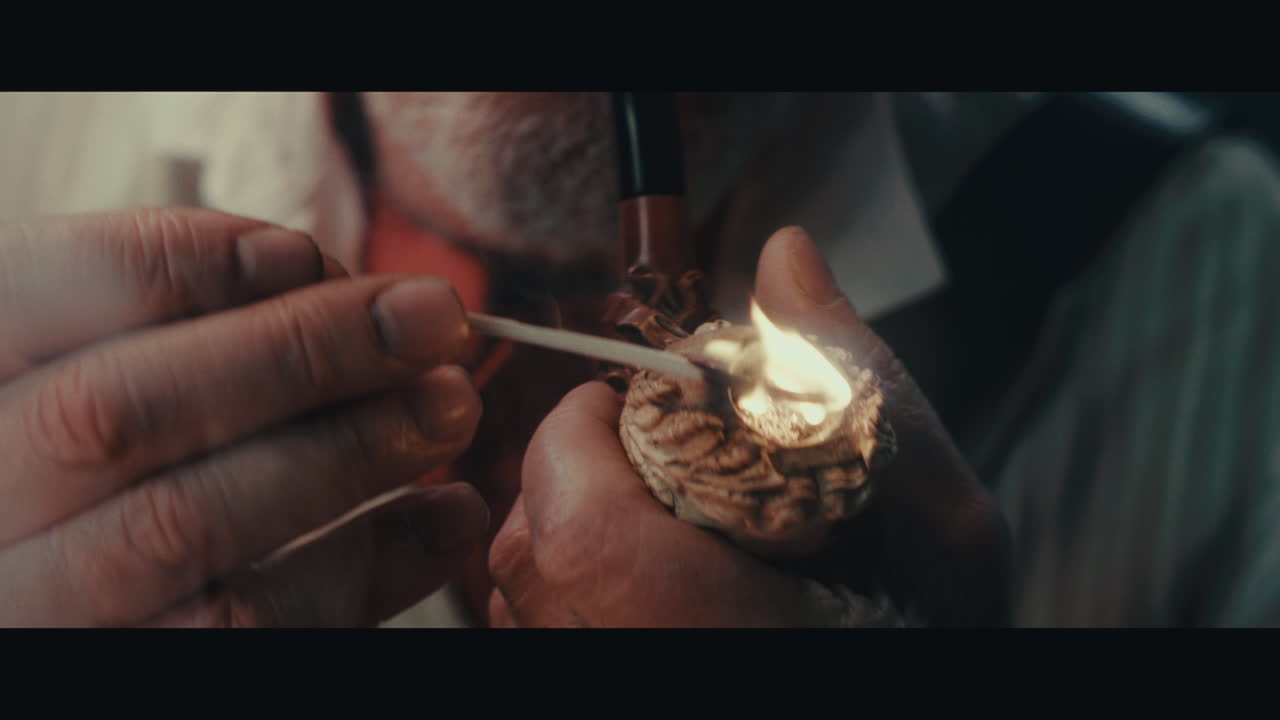 An old pirate capitan smokes a pipe inside the sailing ship cabin