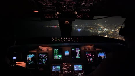 exclusive night view of a cockpit jet during a real approach to the airport of ibiza, spain, in a hazy night