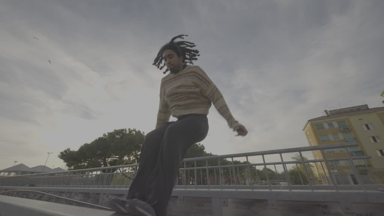 Man Performing Parkour on a Bridge