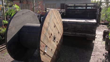 behind farm truck with wood reel, sun light