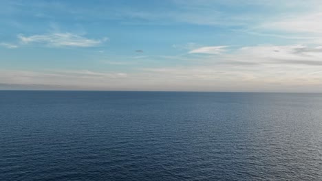 flying along the spanish coast line in europe with water glistening below